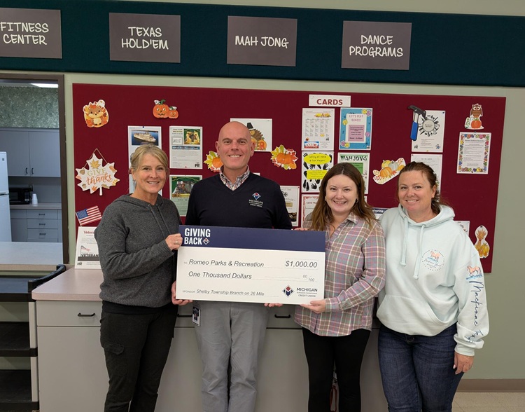 MSGCU staff awarding large check to recipients